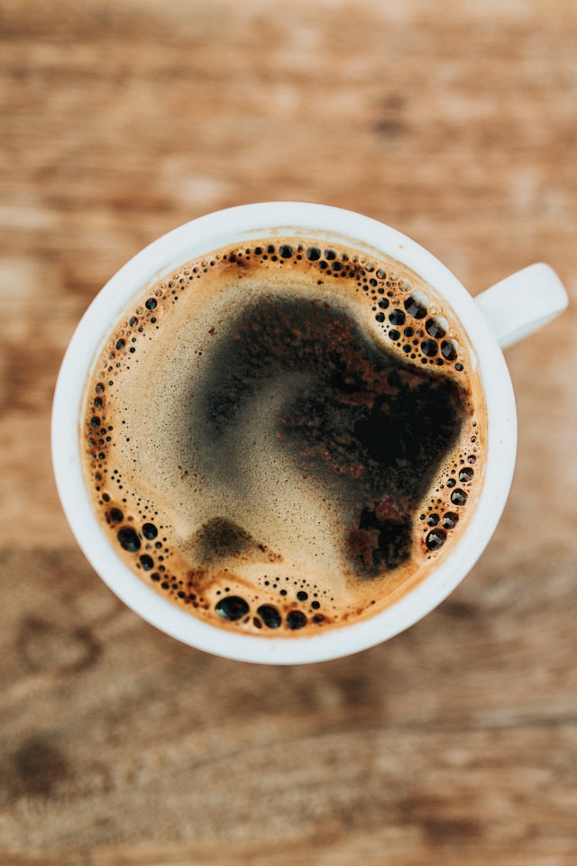 A white mug of black coffee viewed from the top